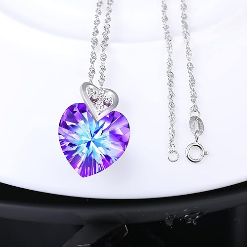 Infinionly Heart of the Ocean crystal necklace with a sterling silver pendant featuring a mini heart and cross design.