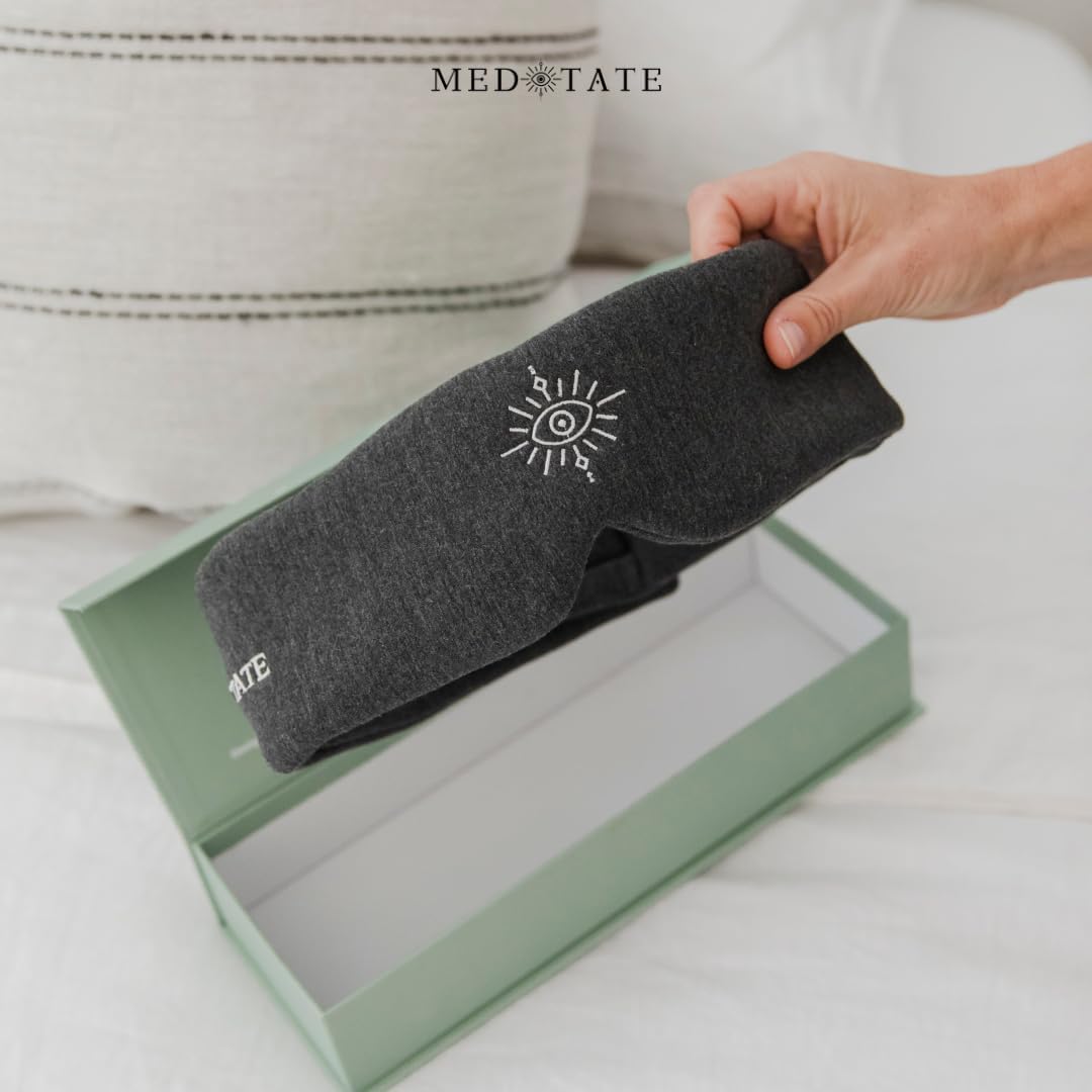 Black MEDEYETATE total blackout sleep mask with ultra-soft cotton, adjustable strap, breathable design for deep sleep and relaxation.
