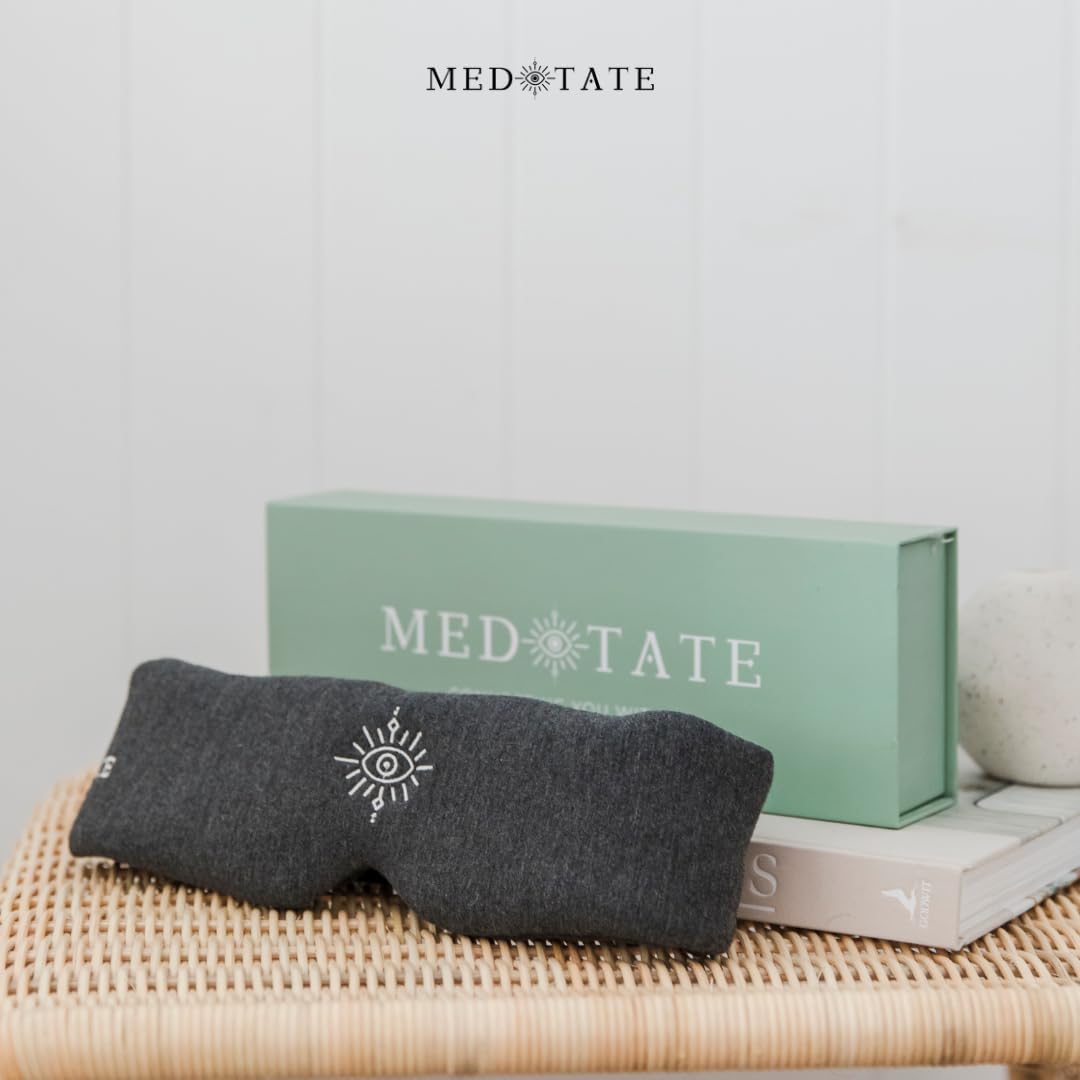 Ultra-soft black sleep mask by MEDEYETATE with adjustable straps, breathable cotton, ideal for deep sleep, relaxation, and travel.
